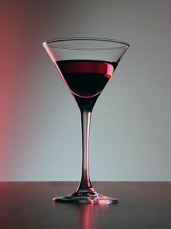 A sophisticated single glass of rich red wine in a chic setting. HD phone wallpaper