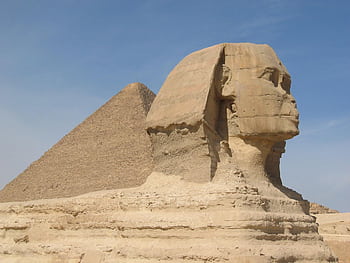 Iconic view of the Great Sphinx and Pyramid of Giza in Egypt under a clear sky. HD wallpaper