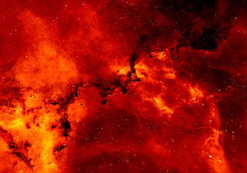 A stunning view of a red cosmic nebula, glowing intensely against a backdrop of stars. HD wallpaper