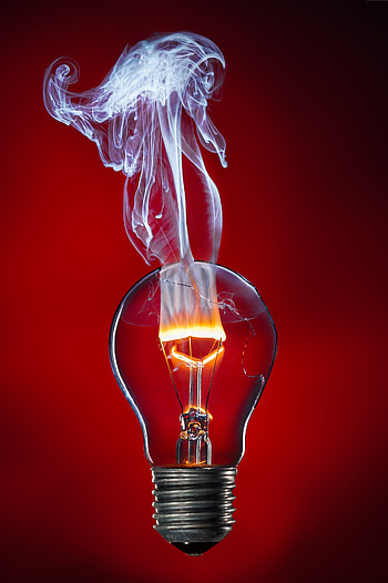 Burning filament of a light bulb with damaged glass bulb, man made HD phone wallpaper