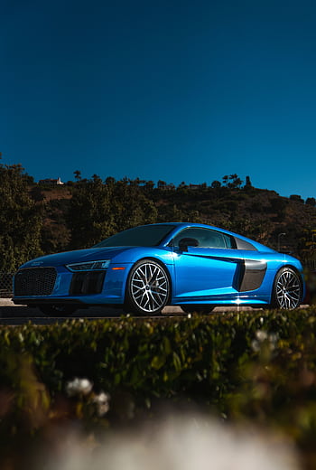A vibrant blue Audi R8 coupe parked in sunny Calabasas with lush hillside background. HD phone wallpaper