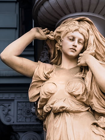 Close-up view of an intricate stone sculpture depicting a woman in a Vienna museum. HD phone wallpaper