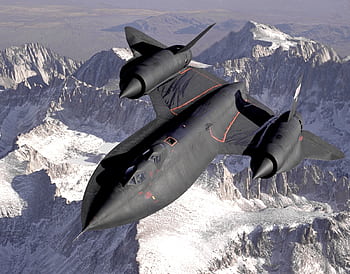 Lockheed SR-71 Blackbird flying over a snowy mountain range, showcasing advanced military aviation. HD wallpaper