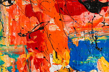 An abstract painting featuring bold and vibrant colors with fluid brushstrokes and splashes. HD wallpaper