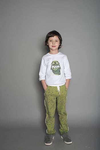 Young boy standing confidently in casual outfit against grey background. HD phone wallpaper