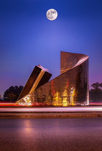 Modern sculpture illuminated under a full moon in Islamabad at night. HD phone wallpaper