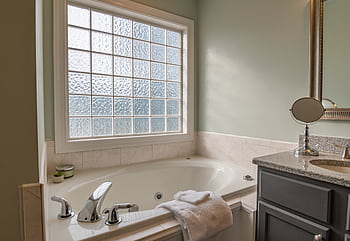 Stylish modern bathroom featuring a luxury bathtub, sleek sink, and large window. Perfect for relaxation. HD wallpaper