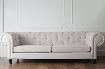 Luxurious white sofa in a modern minimalist interior with wooden flooring. HD wallpaper