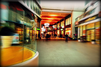 Explore the lively atmosphere of a modern shopping mall in Hoofddorp, Netherlands, captured with vibrant colors and motion blur. HD wallpaper