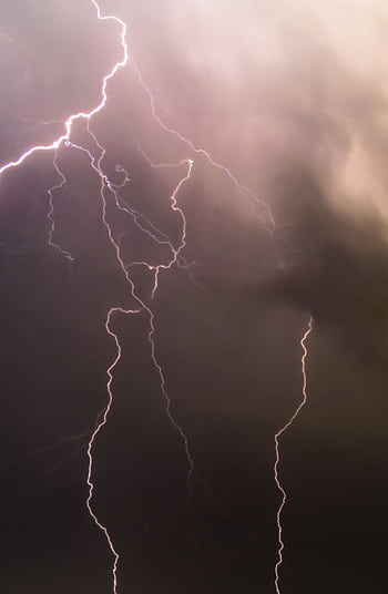 Captivating long exposure of lightning bolts during a nighttime thunderstorm showcasing nature's power. HD phone wallpaper