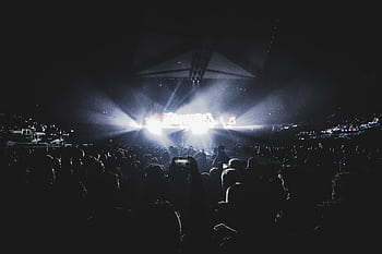 Dynamic concert scene with an energetic crowd at night in a London stadium. HD wallpaper