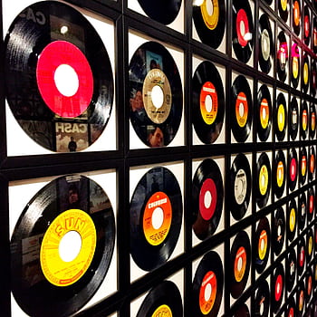 Colorful vinyl records framed and displayed on a wall, showcasing a retro music theme. HD phone wallpaper