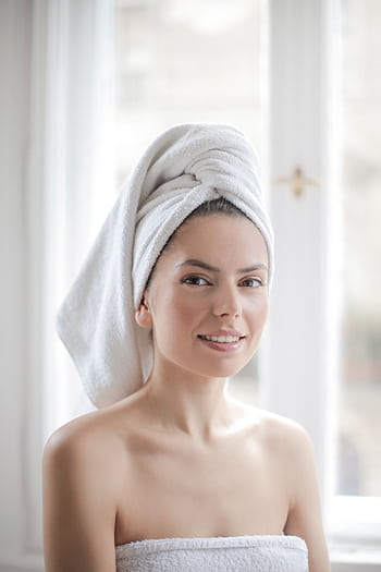 Young woman with towel wrapped around her head in a bright bathroom setting. HD phone wallpaper