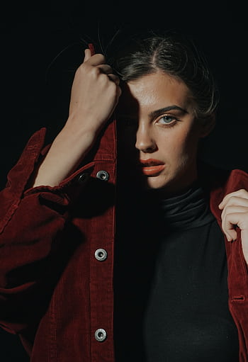 Dramatic portrait featuring a woman with strong shadow contrast, wearing a red jacket. HD phone wallpaper