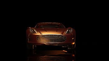 Front view of a luxurious sports car in a dark setting, showcasing elegance and design. HD wallpaper