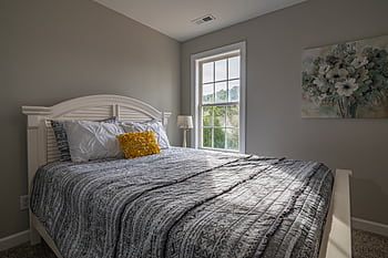 A warm, inviting bedroom with a double bed and natural light streaming in. HD wallpaper