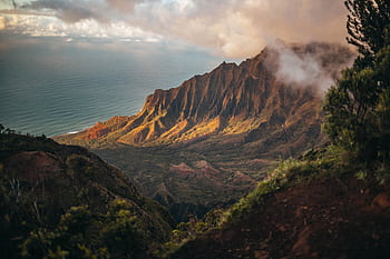 A stunning view of the Kalalau Valley with mountains and ocean in Kauai, Hawaii. HD wallpaper