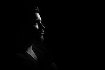 Profile portrait of a man in black and white, emphasizing shadows and highlights. HD wallpaper