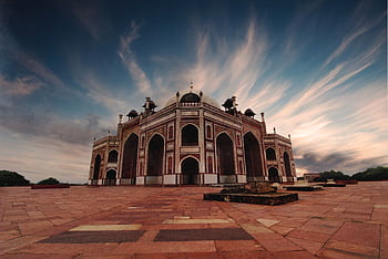 Stunning low angle view of Humayun's Tomb in Delhi against a dramatic sky at sunset. HD wallpaper