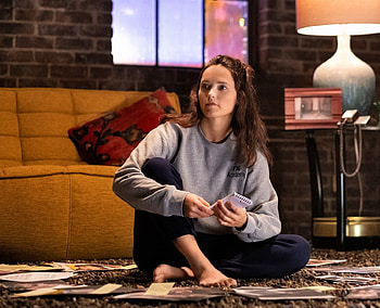 REBECCA REEDS, siting on floor, sofa, table lamp, window, brunette, black pants, grey sweat shirt HD wallpaper