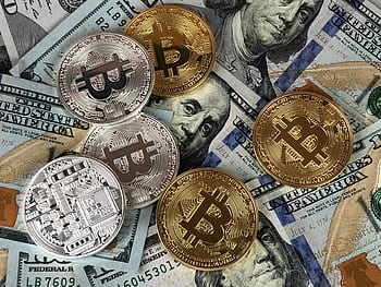Close-up of bitcoins and US dollar bills symbolizing modern finance and cryptocurrency. HD wallpaper