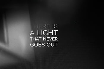 Inspirational quote 'There is a light that never goes out' on a black gradient background. HD wallpaper