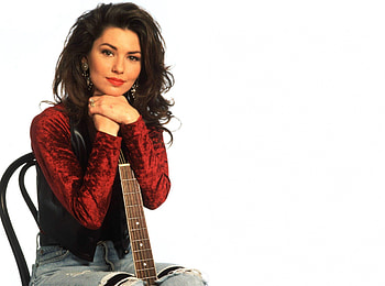 Shania Twain, red lips, chair, red blouse, smile, pretty eyes, guitar, country singer, jeans, long dark hair, female HD wallpaper