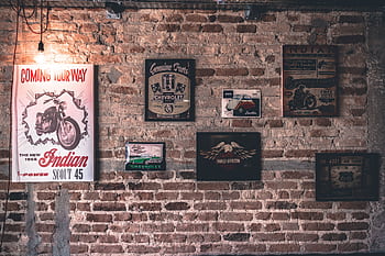 Retro wall art featuring motorcycle and car signs on a rustic brick wall. HD wallpaper
