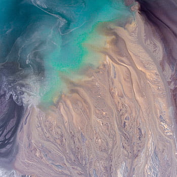 Stunning abstract aerial view showcasing turquoise waters blending with sandy textures, ideal for creative backgrounds. HD phone wallpaper
