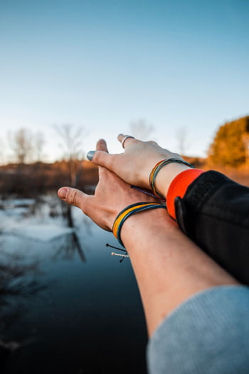 A couple embracing a romantic moment by a serene lake, captured at sunset with a warm, loving vibe. HD phone wallpaper