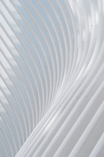 A modern white curved architectural structure with elegant lines and geometric patterns. HD phone wallpaper