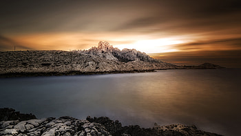 Sea Coast Stones Rocks Under Black Clouds Sky During Sunset Nature HD wallpaper