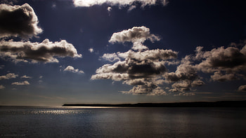 suspended in the air, blue, sea, reflection, clouds, sky, sun, land HD wallpaper