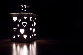 A square lantern with heart-shaped cutouts casting a warm glow in the dark. HD wallpaper