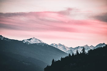 Captivating sunset over snow-capped peaks in Jenbach, Austria. HD wallpaper
