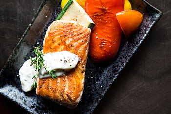 Delicious grilled salmon served with roasted vegetables and herb sauce. HD wallpaper