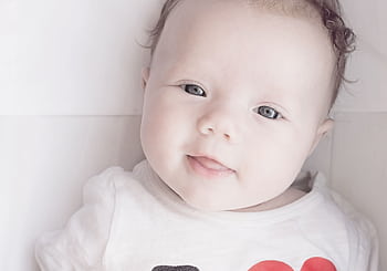 Close-up portrait of a cute smiling baby with light skin and bright eyes. HD wallpaper