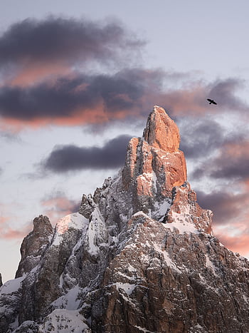 Majestic snow-covered mountain peaks under dramatic skies at sunrise in Trentino-Alto Adige. HD phone wallpaper