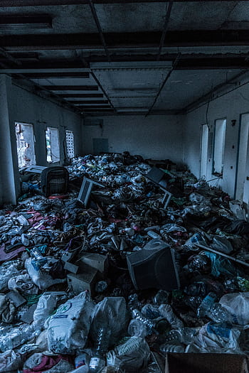 Decrepit indoor room cluttered with heaps of garbage and waste materials. HD phone wallpaper