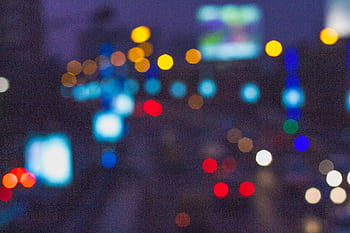 Blurred night view of a vibrant cityscape in Kolkata, India with colorful bokeh lights. HD wallpaper