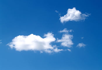 Crisp white clouds float in a vibrant blue sky, perfect for backgrounds. HD wallpaper
