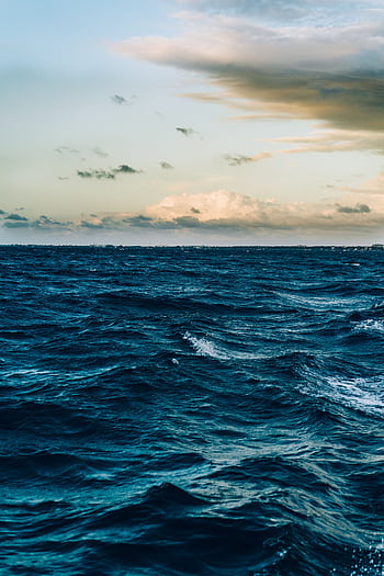 A captivating view of ocean waves under a dramatic twilight sky, offering a peaceful seascape. HD phone wallpaper