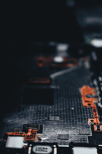 Close-up of a dark circuit board showcasing electronic components and connections. HD phone wallpaper