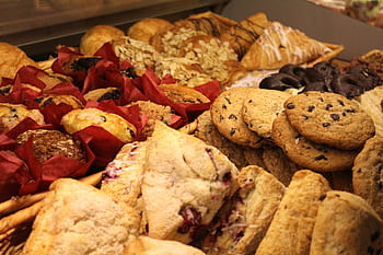 A delicious assortment of baked goods including cookies, muffins, and pastries ideal for breakfast or snack. HD wallpaper