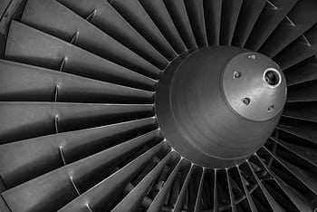 Detailed black and white of an airplane turbine engine showcasing blades and craftsmanship. HD wallpaper