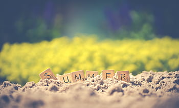 Scrabble tiles forming the word 'summer' in sand with a blurred background, evoking warm vibes. HD wallpaper