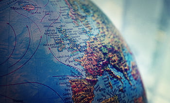 Detailed close-up of a globe showing parts of Europe and the Atlantic Ocean. HD wallpaper
