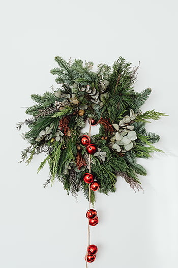 A beautiful Christmas wreath adorned with red bells on a white background. HD phone wallpaper