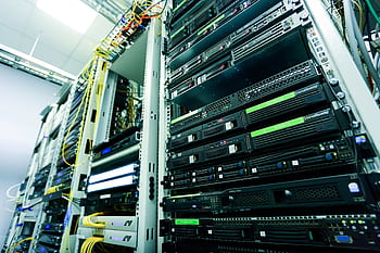 High-tech server rack in a secure data center with network cables and hardware components. HD wallpaper