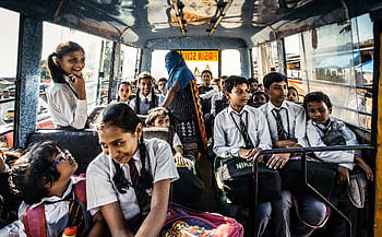 Group of school children in uniforms on a bus in Wadgaon, India. HD wallpaper